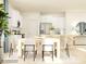 Open-concept dining area with a modern table, chairs, and views of the kitchen at 1606 Swallow Tail Dr, Cramerton, NC 28012