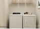 Functional laundry room featuring modern appliances, a white wire rack, and bright lighting at 1606 Swallow Tail Dr, Cramerton, NC 28012