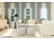 Cozy living room featuring a white sectional, soft blue curtains and ample natural light at 1606 Swallow Tail Dr, Cramerton, NC 28012