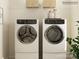 Bright laundry room features side-by-side washer and dryer with storage shelves above at 1616 Swallow Tail Dr, Cramerton, NC 28012