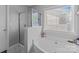 Bathroom featuring a soaking tub, shower, and large window for natural lighting at 10418 Cullen Ct, Charlotte, NC 28278