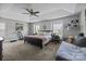 Large bedroom with a trey ceiling, a ceiling fan, and large windows offering natural light at 10418 Cullen Ct, Charlotte, NC 28278