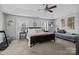 Bright bedroom with a trey ceiling, a ceiling fan, large windows, and neutral decor at 10418 Cullen Ct, Charlotte, NC 28278
