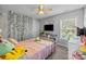 Bright bedroom with window, ceiling fan, and decorative vine wall accent at 10418 Cullen Ct, Charlotte, NC 28278