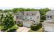 Picture of a two-story home with stone accents, a two-car garage, a well-kept lawn and a tree at 10418 Cullen Ct, Charlotte, NC 28278