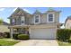 Charming two-story home featuring a stone and vinyl facade with a two-car garage and manicured landscaping at 10418 Cullen Ct, Charlotte, NC 28278