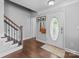 Inviting foyer with hardwood floors, staircase, and a front door with decorative glass, and gray walls at 10418 Cullen Ct, Charlotte, NC 28278