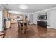 Open kitchen and dining area with wood cabinets, stainless steel appliances, and an island with seating at 10418 Cullen Ct, Charlotte, NC 28278