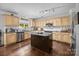 Spacious kitchen featuring an island, stainless steel appliances, and light wood cabinets at 10418 Cullen Ct, Charlotte, NC 28278