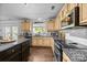 Well-lit kitchen with granite countertops, stainless appliances, and white subway tile backsplash at 10418 Cullen Ct, Charlotte, NC 28278