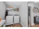 Bright laundry room with new washer and dryer next to an open doorway at 10418 Cullen Ct, Charlotte, NC 28278