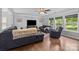 Spacious living room with hardwood floors, large windows, and comfortable seating arrangement at 10418 Cullen Ct, Charlotte, NC 28278