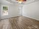 Spacious primary bedroom has hardwood floors, tray ceiling, and dual windows at 1634 Dawson Ct, Rock Hill, SC 29730
