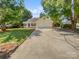 Charming home featuring blue shutters, a well-manicured lawn, and a long driveway, with mature trees offering shade at 1634 Dawson Ct, Rock Hill, SC 29730