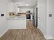 Well-lit kitchen features white cabinets, stainless steel appliances, and a breakfast bar at 1634 Dawson Ct, Rock Hill, SC 29730