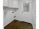 Well-lit laundry room provides storage and convenience at 1634 Dawson Ct, Rock Hill, SC 29730