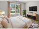 Bright main bedroom features a large window, modern decor, and a cozy rug, creating a relaxing retreat at 1634 Dawson Ct, Rock Hill, SC 29730