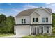 Charming two-story home features a covered entry, attached garage, and beautiful landscaping at 180 Glenn Dr, Mooresville, NC 28115