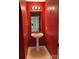 Red half bath with a pedestal sink and modern fixtures at 2113 Ballingarry Dr, Statesville, NC 28625