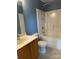 Bright bathroom featuring a shower-tub, with a vanity and mirror at 2113 Ballingarry Dr, Statesville, NC 28625