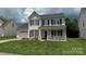 Charming two-story home with black shutters and a well-maintained lawn at 2113 Ballingarry Dr, Statesville, NC 28625