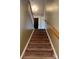 Carpeted stairway with wood railing at 2113 Ballingarry Dr, Statesville, NC 28625