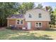 The home's backyard features brickwork and a traditional exterior that complements the backyard's green space at 2508 Wood Star Ct, Matthews, NC 28105