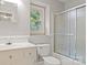 Bathroom with window, white vanity, toilet and tiled shower/tub at 2508 Wood Star Ct, Matthews, NC 28105