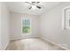 Carpeted bedroom with two windows and ceiling fan at 2508 Wood Star Ct, Matthews, NC 28105