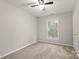 Neutral bedroom featuring a ceiling fan, window, and a closet at 2508 Wood Star Ct, Matthews, NC 28105