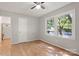 Bright bedroom with hardwood floors, two windows, ceiling fan, and closet at 2508 Wood Star Ct, Matthews, NC 28105