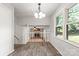 Bright dining room with wainscotting, wood flooring, and views of the connected living area at 2508 Wood Star Ct, Matthews, NC 28105