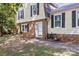 Charming two-story home with a brick foundation, yellow siding, black shutters, and a well-manicured lawn at 2508 Wood Star Ct, Matthews, NC 28105