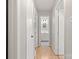 Hallway with wood flooring and view into the bathroom at 2508 Wood Star Ct, Matthews, NC 28105