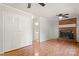 Spacious living room with brick fireplace, ceiling fans, and a closet at 2508 Wood Star Ct, Matthews, NC 28105