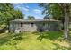 The backyard features a grassy lawn and mature trees, providing a private outdoor space at 3015 Lasalle St, Charlotte, NC 28216