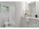 Updated bathroom features a toilet, vanity, modern fixtures, and shower with bright, natural light at 3015 Lasalle St, Charlotte, NC 28216
