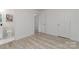 Neutral bedroom featuring a closet, a door to another room, wood-look flooring, and fresh white paint at 3015 Lasalle St, Charlotte, NC 28216
