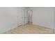 Bedroom with a closet, a door, wood-look flooring, and fresh white paint at 3015 Lasalle St, Charlotte, NC 28216