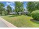View of a charming single story home with a well-manicured lawn and mature trees in a residential neighborhood at 3015 Lasalle St, Charlotte, NC 28216