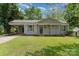 Charming single-story home featuring gray siding, a covered carport, and a well-maintained front lawn at 3015 Lasalle St, Charlotte, NC 28216