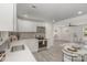 Bright kitchen with white cabinetry, stainless steel appliances, an open layout, and gray wood-look floors at 3015 Lasalle St, Charlotte, NC 28216