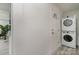 Laundry room area features stacked white washer and dryer near the back door at 3015 Lasalle St, Charlotte, NC 28216