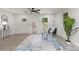 Bright living room featuring gray flooring, a modern ceiling fan, and a welcoming entryway at 3015 Lasalle St, Charlotte, NC 28216