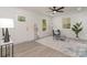 Bright living room with stylish gray flooring, a modern ceiling fan, and lots of natural light at 3015 Lasalle St, Charlotte, NC 28216