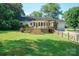 Spacious backyard with deck, mature trees, and partial fencing, ideal for outdoor living at 630 4Th Nw Ave, Hickory, NC 28601