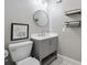 Bathroom with gray vanity, round mirror and modern fixtures at 630 4Th Nw Ave, Hickory, NC 28601