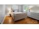 Bright bedroom with hardwood floors, natural light, and a comfortable bed and dresser at 630 4Th Nw Ave, Hickory, NC 28601