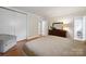 Bedroom featuring hardwood flooring, neutral walls, trim, and furniture with view into bath at 630 4Th Nw Ave, Hickory, NC 28601