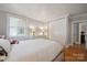 Well-lit bedroom featuring a closet, hardwood flooring, and neutral walls and trim at 630 4Th Nw Ave, Hickory, NC 28601